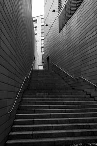 Low angle view of staircase amidst buildings in city