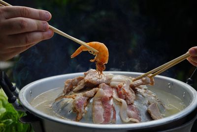 Thailand style bbq grill on a charcoal fire that is located on the bottom with pork, shrimp, squid 