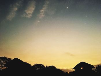 Silhouette trees against sky during sunset