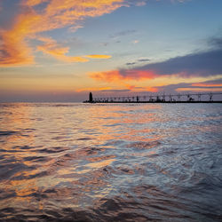 Scenic view of sea against orange sky