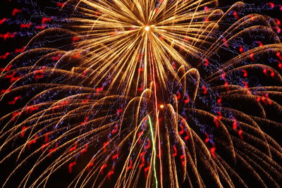 Low angle view of firework display at night