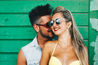 Portrait of smiling young man wearing sunglasses outdoors