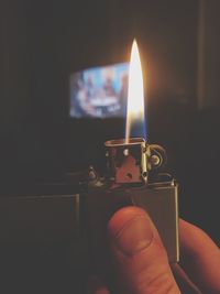 Close-up of hand holding candle