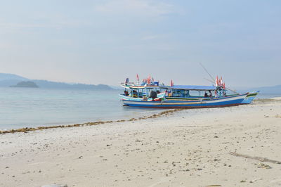 View of boats on beach against sky