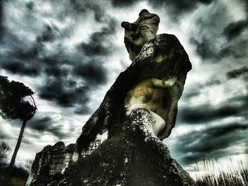 Low angle view of statue against cloudy sky