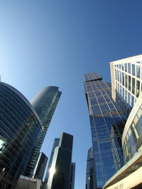 Low angle view of modern building against blue sky