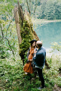 Rear view of couple standing in forest