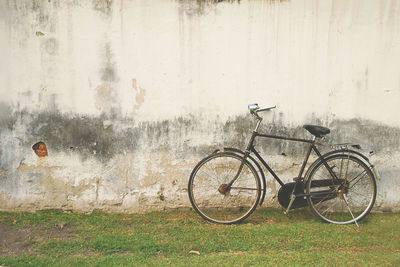 Bicycle parked on wall