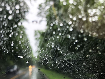 Raindrops on wet windshield during rainy season