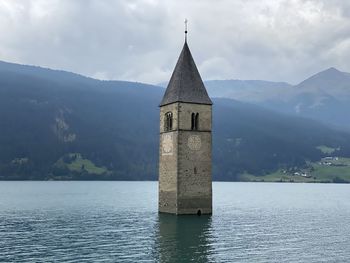 Tower by building against sky