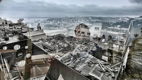 High angle view of town by sea against sky