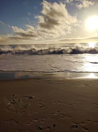 Scenic view of beach against sky during sunset