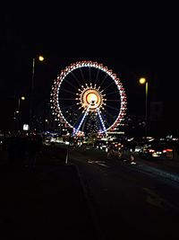 Illuminated ferris wheel at night