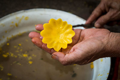 Cropped hands making wax flower