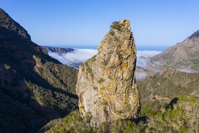 Scenic view of mountains against blue sky