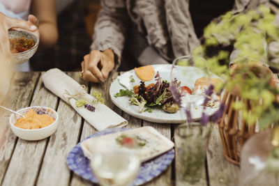 Mature woman sitting with food on table