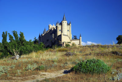 Exterior of old building against clear blue sky