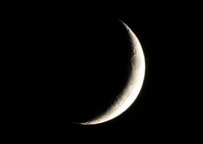 Low angle view of half moon against sky at night