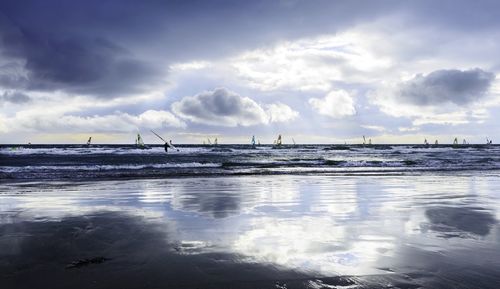 Scenic view of sea against cloudy sky