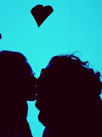 Close-up of silhouette friends against sky