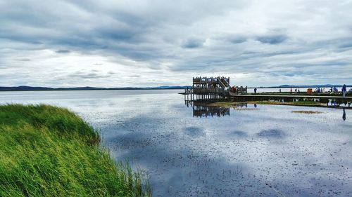 Scenic view of sea against cloudy sky