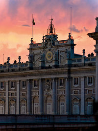 Building against cloudy sky during sunset