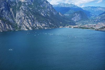 Panoramic view of garda lake from torbolle direction with sailing regatta.