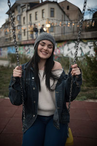 Young woman sitting on swing