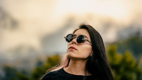 Portrait of young woman wearing sunglasses outdoors