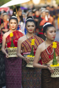 Group of people standing against blurred background