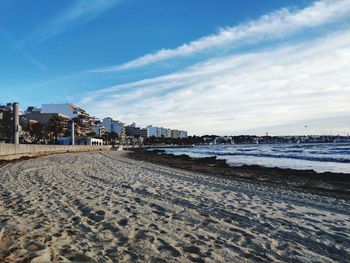 Scenic view of beach against sky in city