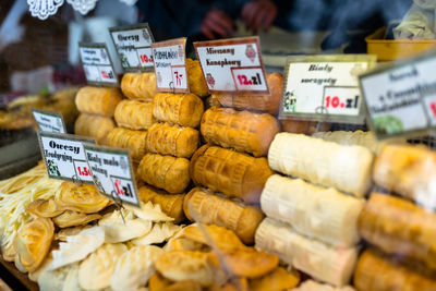 Smoked sheep cheese called in the polish mountains oscypek,arranged in piles at the fair with price