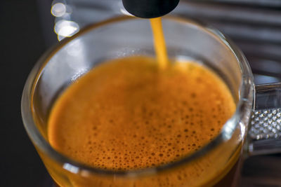 Closeup of cappuccino machine brewing fresh cup of coffee