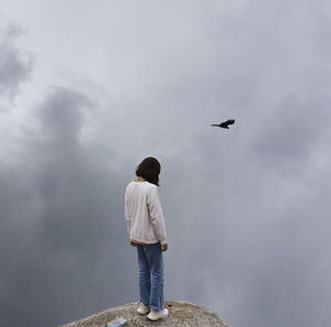 Rear view of man standing against sky