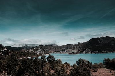 Scenic view of sea and mountains against sky