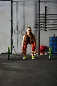 Full length of man sitting on wall