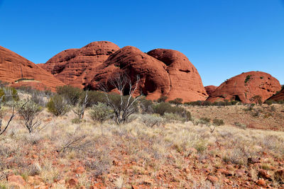 Rock formations in desert against clear blue sky