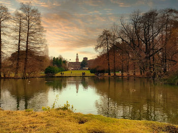 Scenic view of lake against sky at sunset