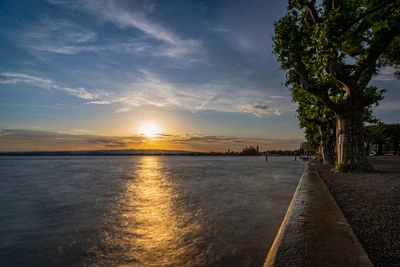 Scenic view of lake zug against sky during sunset