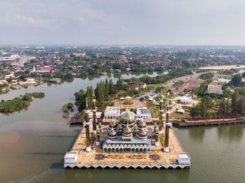 High angle view of crystal mosque by river 