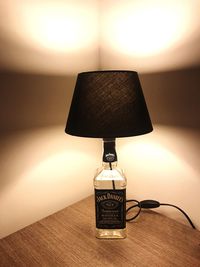 Close-up of electric lamp on table at home