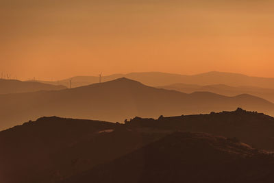 Scenic view of silhouette mountains against sky during sunset