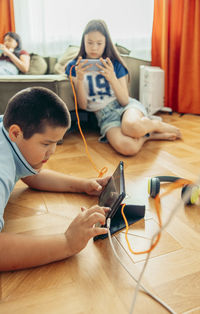 High angle view of woman sitting on floor at home