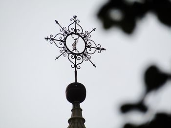 Low angle view of silhouette metal against sky