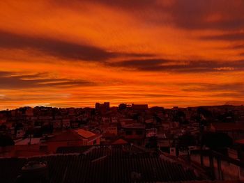 High angle view of townscape against orange sky