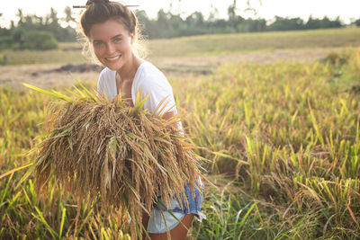 Rear view of woman standing in farm