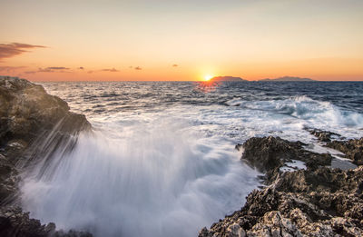 Scenic view of sea against clear sky during sunset