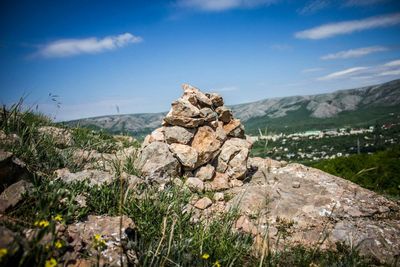 Stack of rocks on mountain against sky