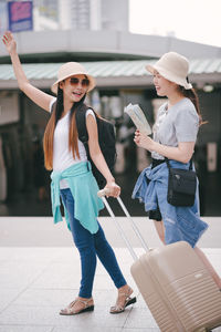 Tourists standing on footpath in city