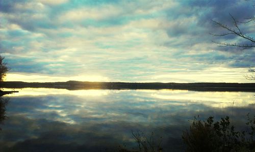 Scenic view of lake against cloudy sky